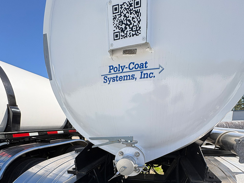 Fiberglass reinforced plastic tank trailer from Poly-Coat Systems showing the tank head and discharge fitting.