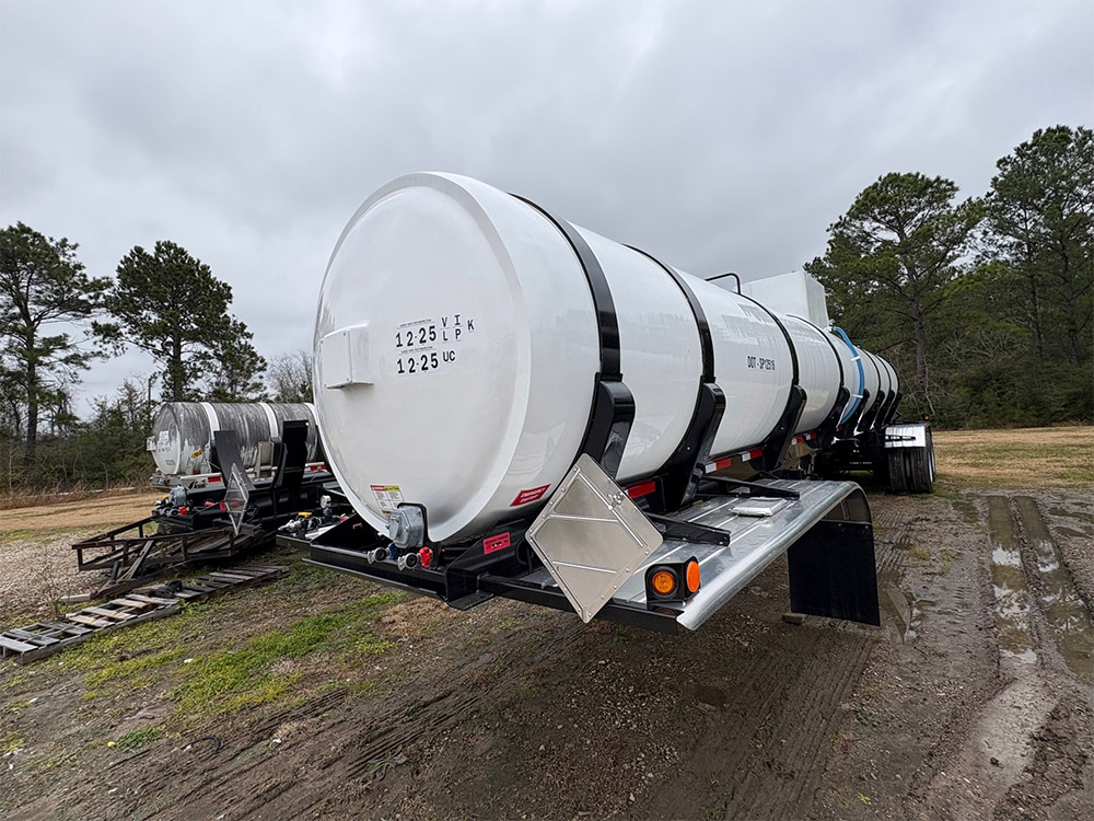Vacuum tank trailer from Poly-Coat Systems showing the white tank head, support frame and fittings.